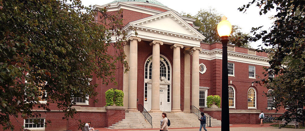 Outside shot of domed brick building with steps and columns and walkway in front.